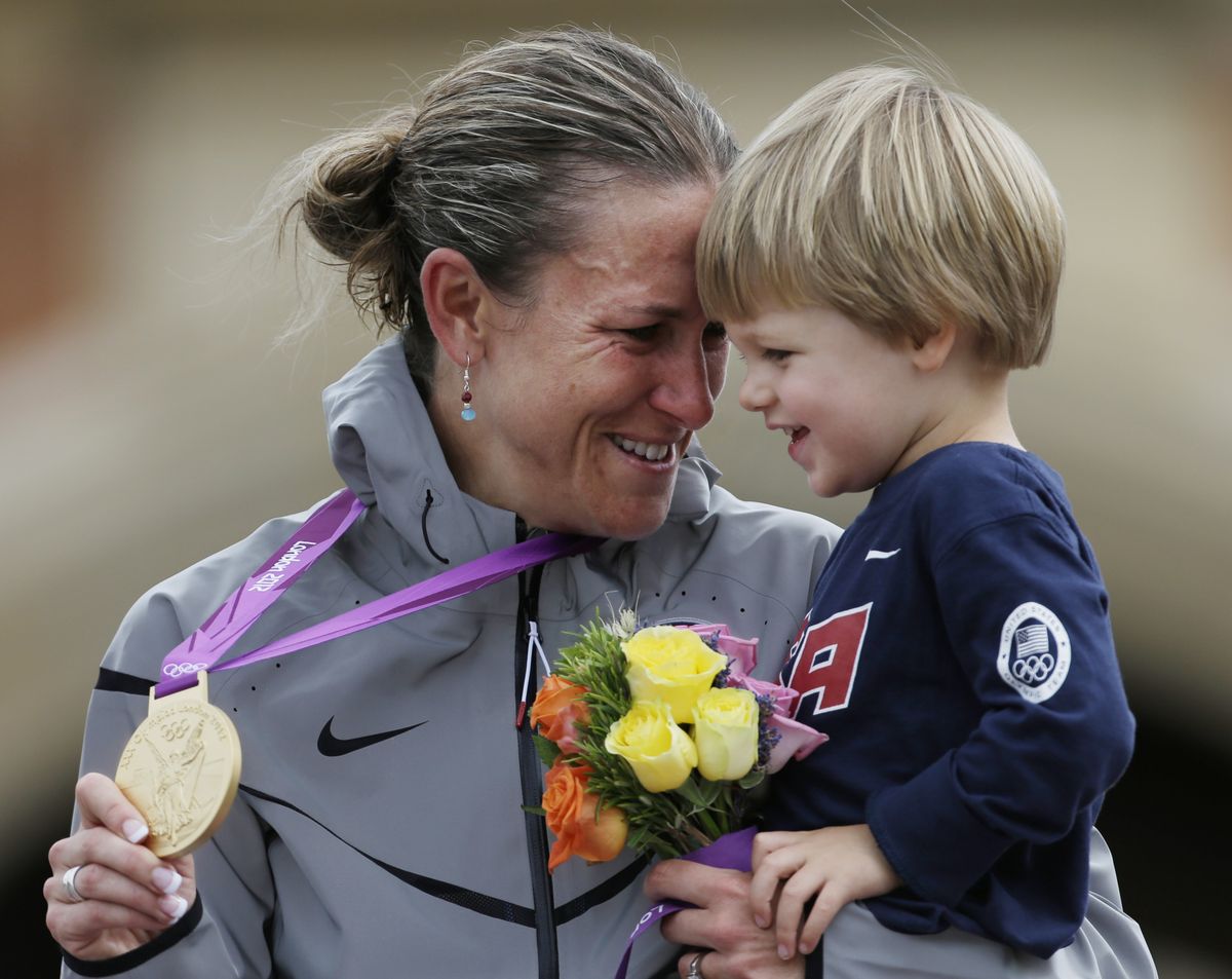Gold medalist Kristin Armstrong, of the United States, celebrates with her son, Lucas, after the women’s individual time trial event. (Associated Press)