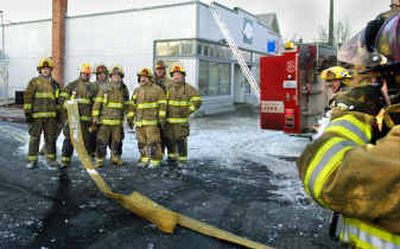 After putting out a fire at the West Central COPS station on Boone, seven firefighters from stations 1 and 4 stand together for a photo by another firefighter. All seven will be laid off in the upcoming city budget cutbacks. From left are Lee Hammons, Kelly Hoyt, Paul Murphy, Ethan Verduin, Tim Loncon, D.J. Hill and Matt Binder.
(Christopher Anderson photos/ / The Spokesman-Review)