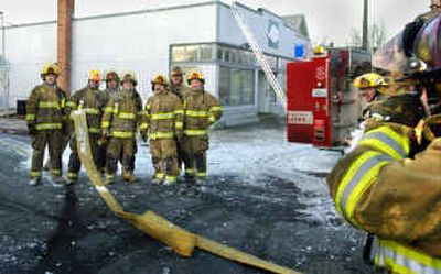 
After putting out a fire at the West Central COPS station on Boone, seven firefighters from stations 1 and 4 stand together for a photo by another firefighter. All seven will be laid off in the upcoming city budget cutbacks. From left are Lee Hammons, Kelly Hoyt, Paul Murphy, Ethan Verduin, Tim Loncon, D.J. Hill and Matt Binder. 
 (Christopher Anderson photos/ / The Spokesman-Review)