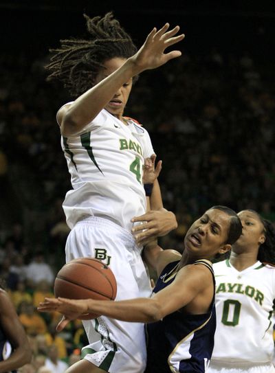 Notre Dame guard Skylar Diggins, right, loses control of the ball in a physical drive against Baylor center Brittney Griner. (Associated Press)