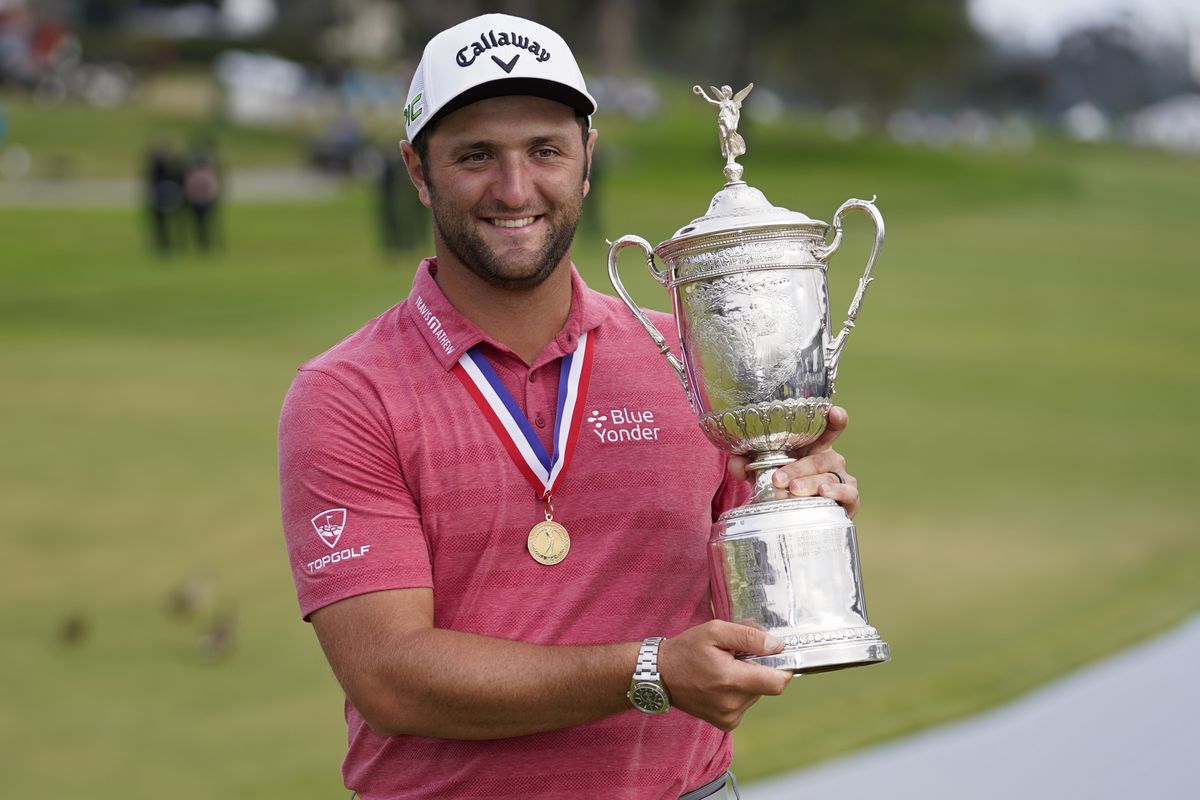 Jon Rahm, of Spain, holds the champions trophy for photographers after the final round of the U.S. Open Golf Championship, Sunday, June 20, 2021, at Torrey Pines Golf Course in San Diego.  (Marcio Jose Sanchez)