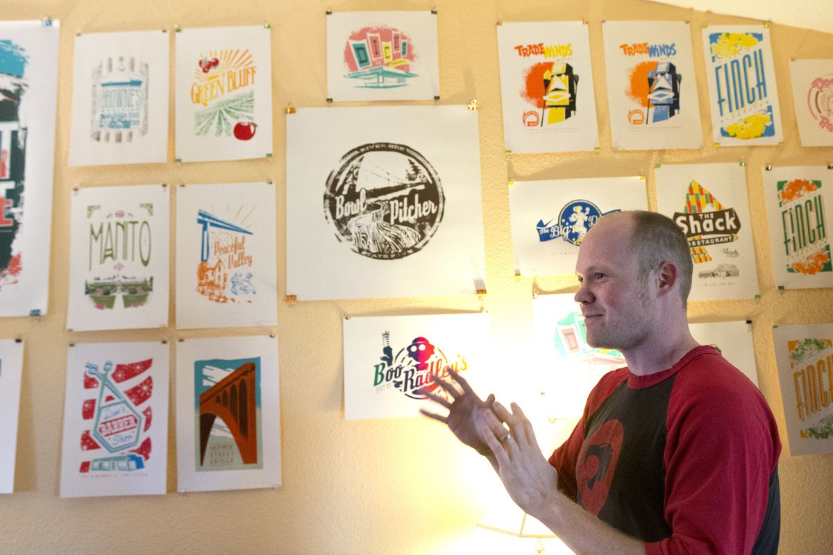 Chris Bovey talks Wednesday about the many screen prints he has made with images of old Spokane, especially business signs and advertising, at his home on the West Plains. (Jesse Tinsley)