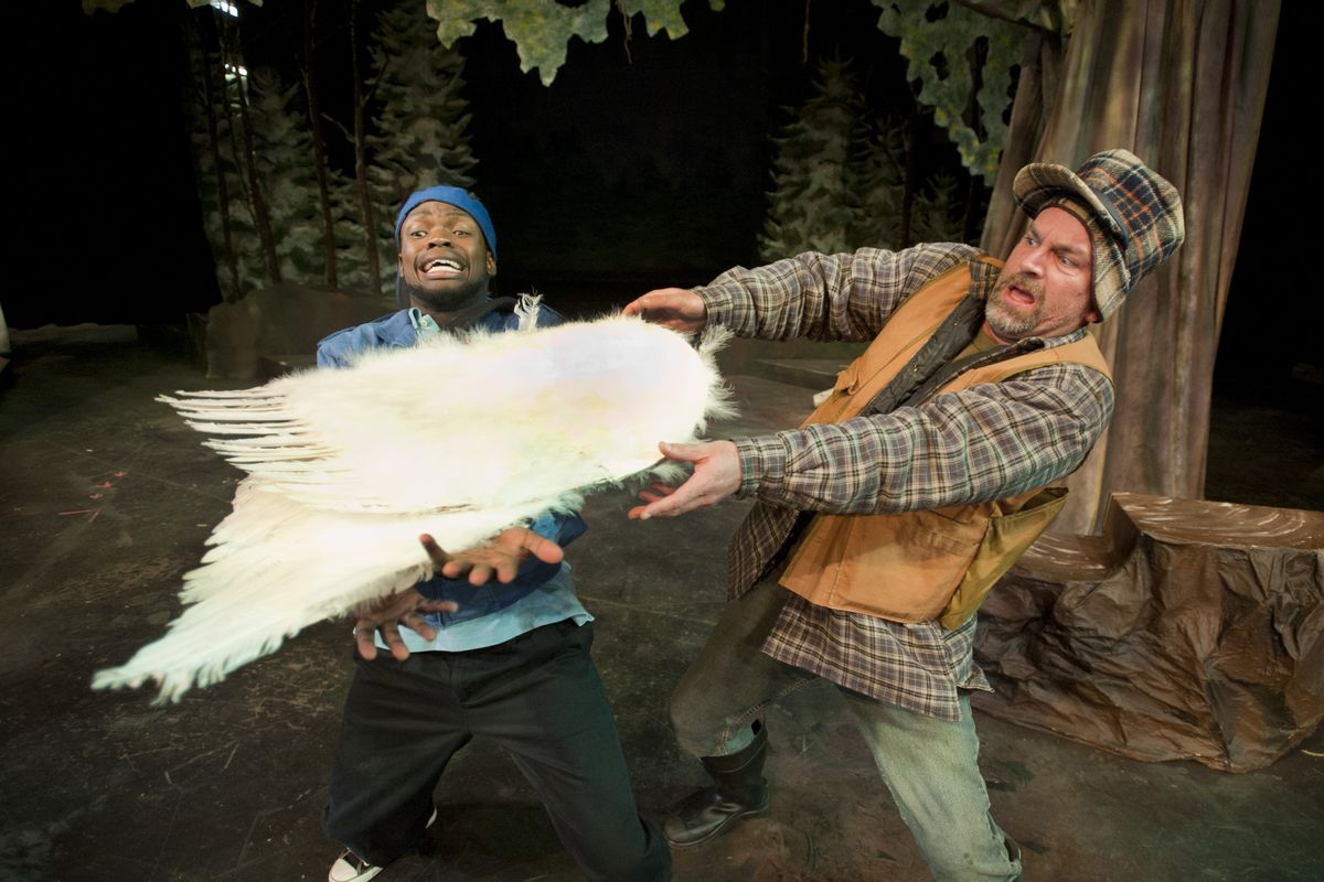 In a scene from the Civic Theatre production of "Duck Hunter Shoots Angel," Jarvis Lunalo as "Lenny," left, and Mark Pleasant as "Duane" try to figure out how to discard a set of angel wings. (Colin Mulvany / The Spokesman-Review)
