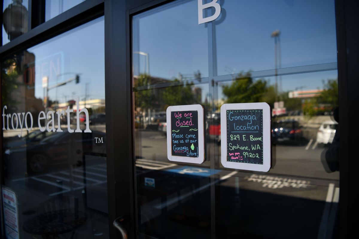 Signs on the doors of the Froyo Earth store at 172 S. Division St. on Thursday, Aug. 1, 2019, note its closure and direct customers to the frozen yogurt restaurant’s location near Gonzaga University. (Tyler Tjomsland / The Spokesman-Review)