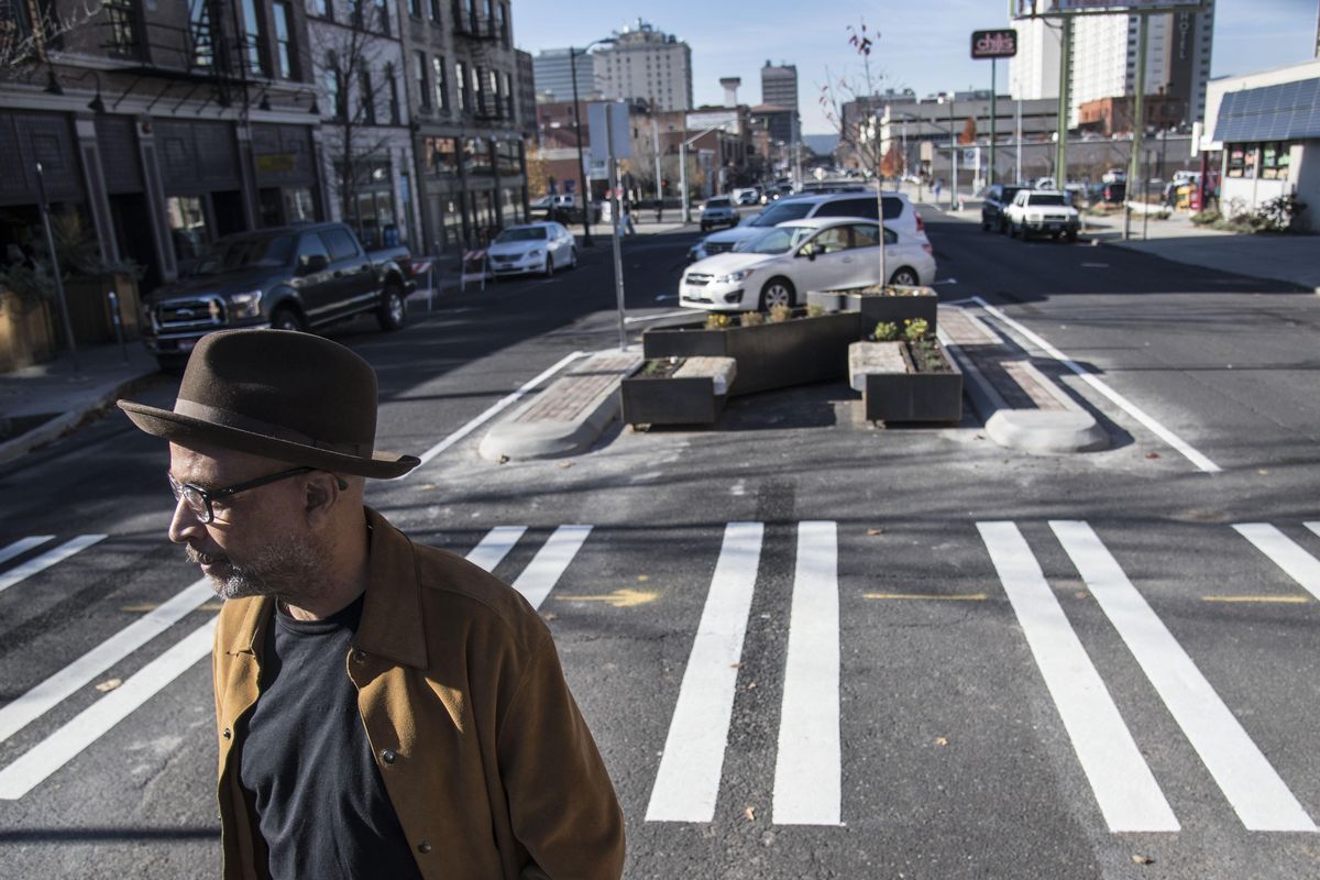 Phil Smith watches the celebration ceremony Friday for the completion of new angle parking and pedestrian safety amenities on Main Avenue near Division Street. (Dan Pelle / The Spokesman-Review)