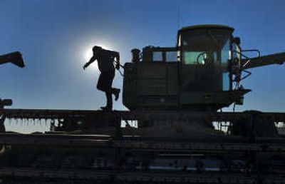 
Near Ritzville, farmer Ron Jirava prepares one of two 1972 John Deere combines that will help bring in this year's crop of 3,500 acres of wheat. With wheat prices over $6  a bushel, farmers across Eastern Washington are harvesting the most profitable crop in a decade.
 (Colin Mulvany / The Spokesman-Review)