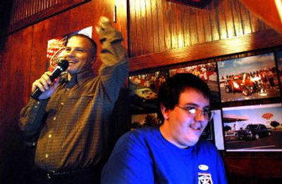 
Todd Tondee, Republican candidate for the Kootenai County Board of Commissioners, pumps his fist and announces his early lead Tuesday evening at the Hot Rod Café in Post Falls. His son, Brad Ratcliff, watches results on a computer. 
 (Jesse Tinsley / The Spokesman-Review)