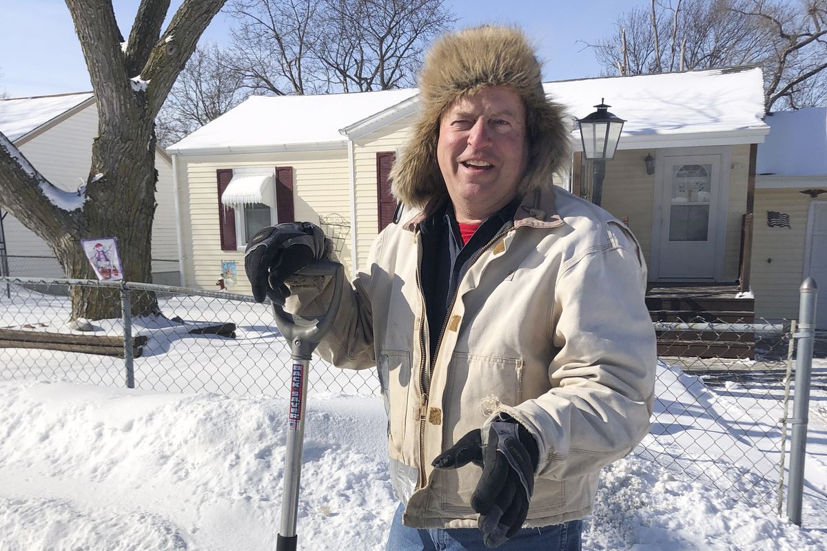 Tracy Fackler pauses from clearing the sidewalk in front of his home, Tuesday, Feb. 9, 2021, in Omaha, Neb. The 63-year-old auto mechanic praises Nebraska Republican Sen. Ben Sasse for condemning former President Donald Trump