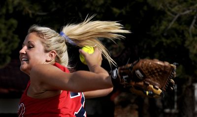 Coeur d’Alene High School senior Amber Coburn practices her pitch Monday. (Kathy Plonka / The Spokesman-Review)