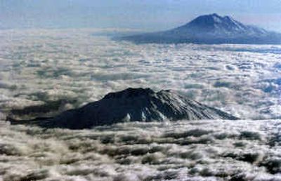 
Mount St. Helens is shown in this aerial photo taken Friday looking east with Mount Adams in background. The lava dome in Mount St. Helens is spreading and growing. 
 (Associated Press / The Spokesman-Review)