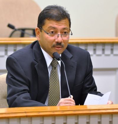 OLYMPIA -- Dr. Arun Raha, state chief economist, reads from his list of Top 10 Arun-isms at a press conference announcing he is resigning to take a job in Cleveland. (Jim Camden)