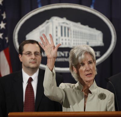 Associate Attorney General Tom Perrelli, left, looks on as Health and Human Services Secretary Kathleen Sebelius discusses a record settlement with drug maker Pfizer over its marketing practices.  (Associated Press / The Spokesman-Review)