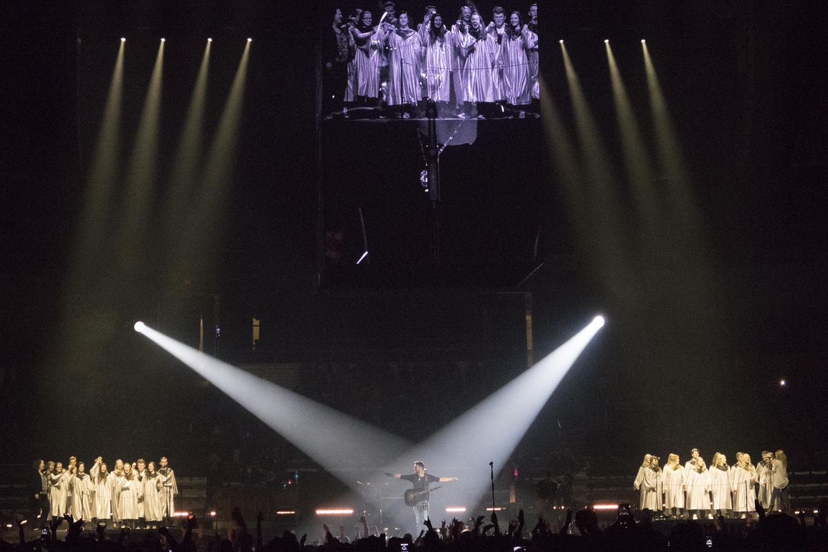 Country singer Eric Church, center, appears with a high school choir during the Spokane Arena tour stop on his Holding My Own tour March 17. (Jesse Tinsley / The Spokesman-Review)