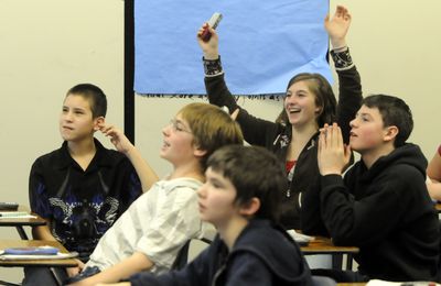 Seventh-grader Summer Weller raises her hands  in victory as she sees her score on a math quiz game recently in Don Eggart’s math class at Cheney Middle School. A number  of Eggart’s students in this class  have trouble in math and might otherwise be in a separate classroom for special help.  (Jesse Tinsley / The Spokesman-Review)