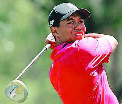 
Tiger Woods tees off on the fourth hole.
 (Associated Press / The Spokesman-Review)