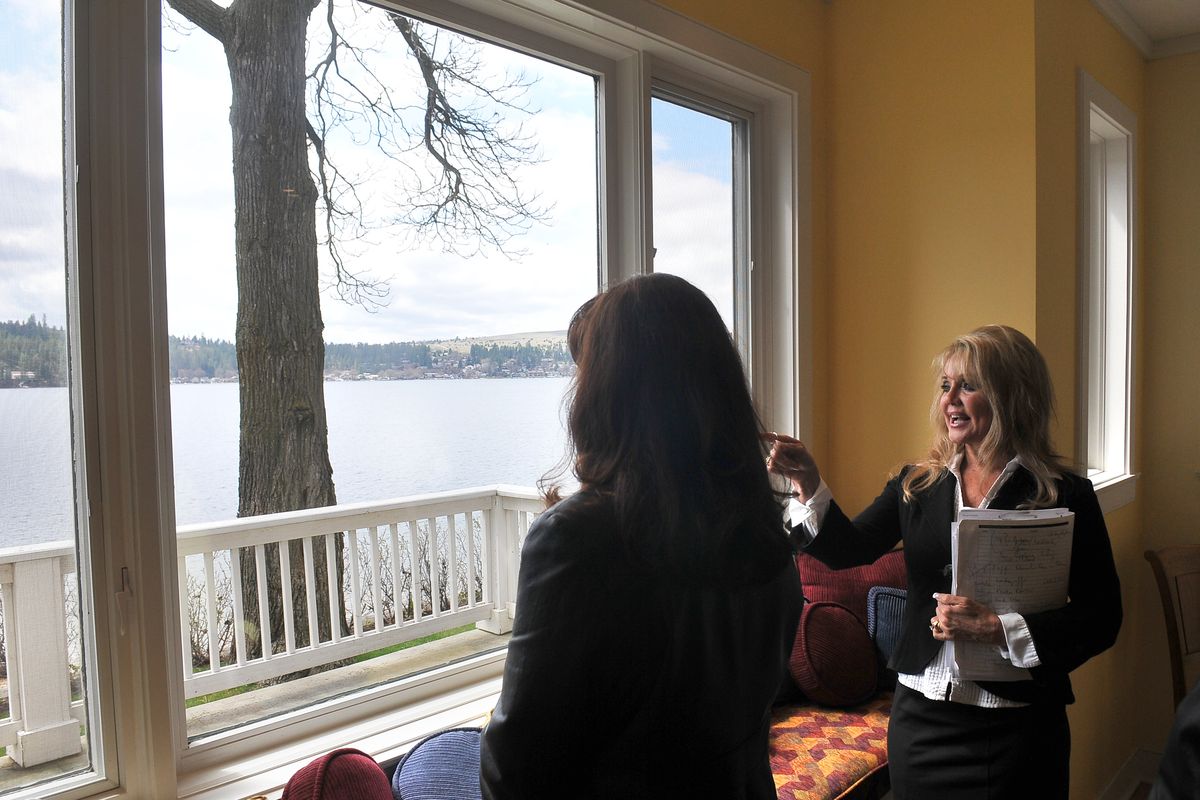 Pam Fredrick, right, of John L. Scott Real Estate, talks about the attributes of a Liberty Lake waterfront home to Maria Hatcher on April 22. Hatcher’s husband works in real estate with Fredrick. The house has an asking price of $1.375 million. (Jesse Tinsley)