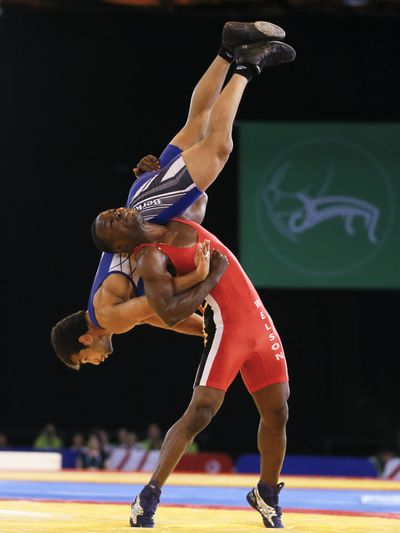 India’s Amit Kumar is lifted by Nigeria’s Ebikwminomo Welson during a gold medal match at the Commonwealth Games. (Associated Press)