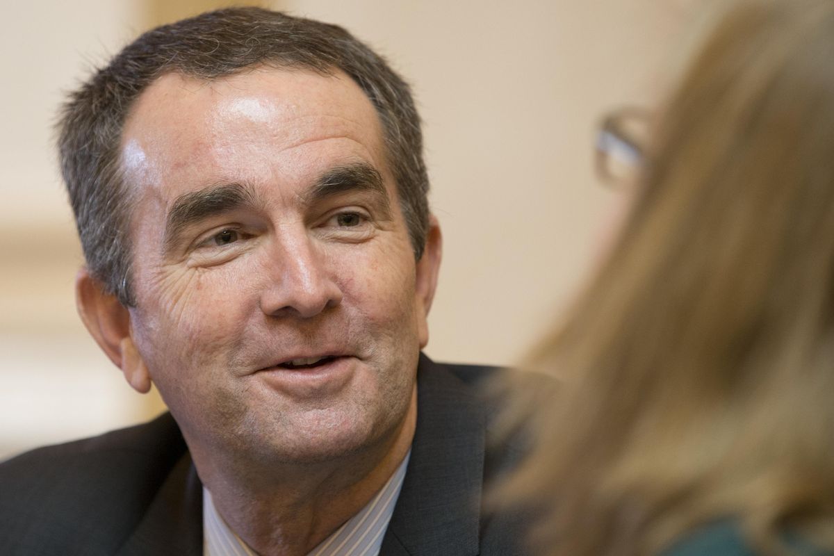 In this Jan. 26, 2016, photo, Virginia Lt. Gov. and Democratic candidate for governor Ralph Northam, left, talks with Senate Chief Deputy Clerk, Tara Perkinson, right, prior to the start of the Senate session at the Capitol in Richmond, Va. (Steve Helber / Associated Press)