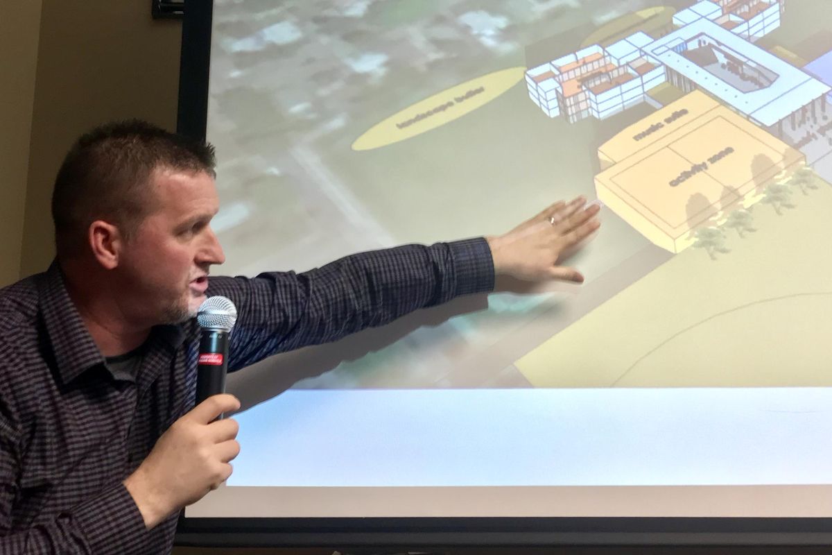 Jeremy Ochse, principal at Sacajawea Middle School, points out features in a preliminary rendering of what a new school could look like, on Thursday, Feb. 21, 2019. (Jim Allen/The Spokesman-Review)