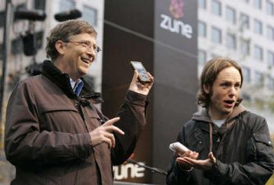 
Bill Gates holds up a Zune duriing a launch party Monday for Microsoft's new music player at Westlake Park in downtown Seattle. The Microsoft boss was joined by John Richards, a DJ with KEXP. 
 (Associated Press / The Spokesman-Review)
