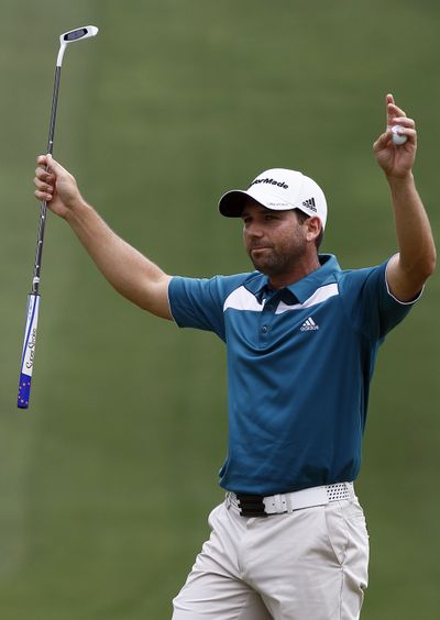Sergio Garcia reacts on the 18th green after winning the rain- delayed Wyndham Championship, his first PGA title since 2008. (Associated Press)