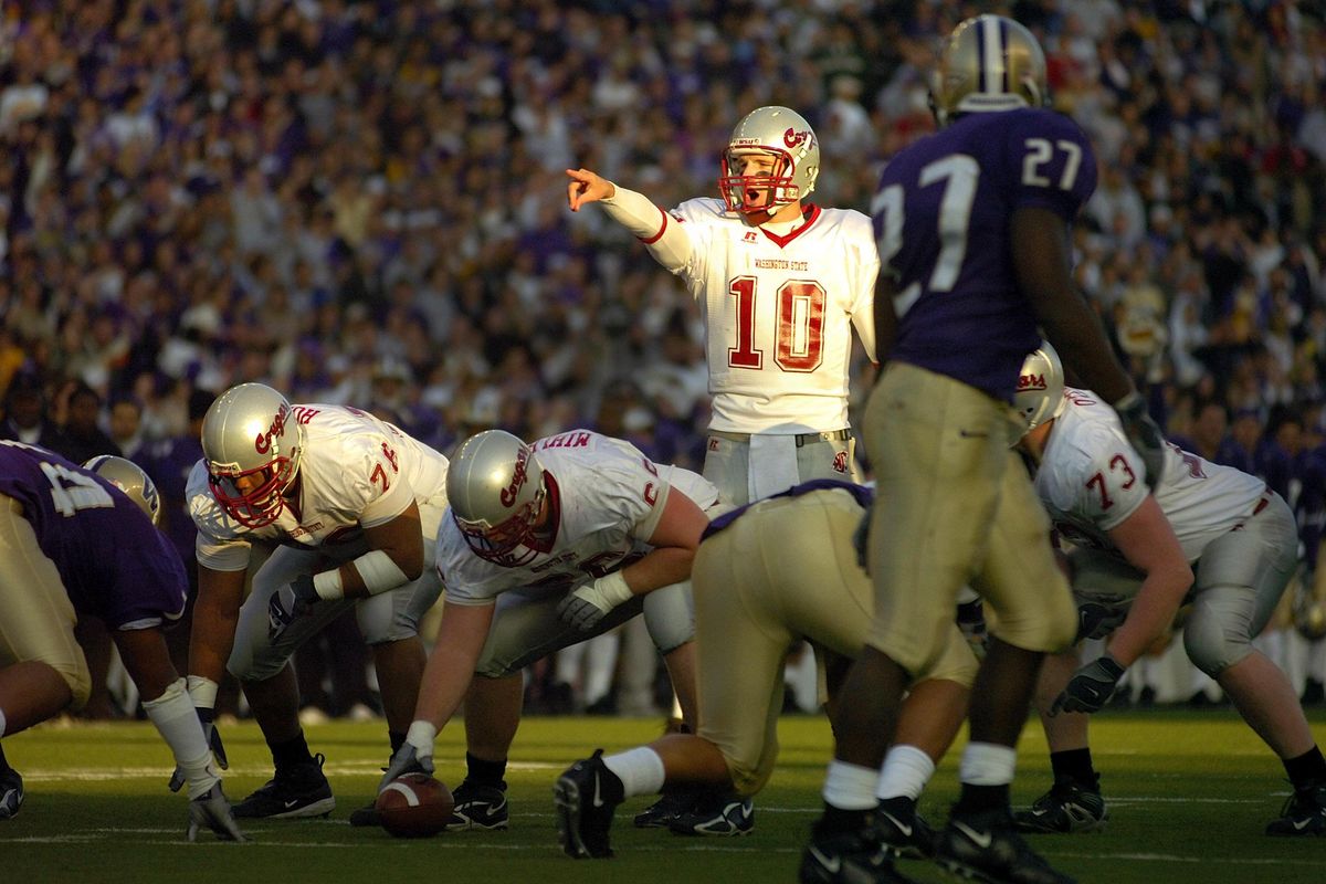 WSU quarterback Alex Brink shouts directions as the last rays of daylight shine on him in the Apple Cup in Husky Stadium Saturday Nov. 19, 2005. Brink led the Cougs to a 26-22 win. (Christopher Anderson / The Spokesman-Review)