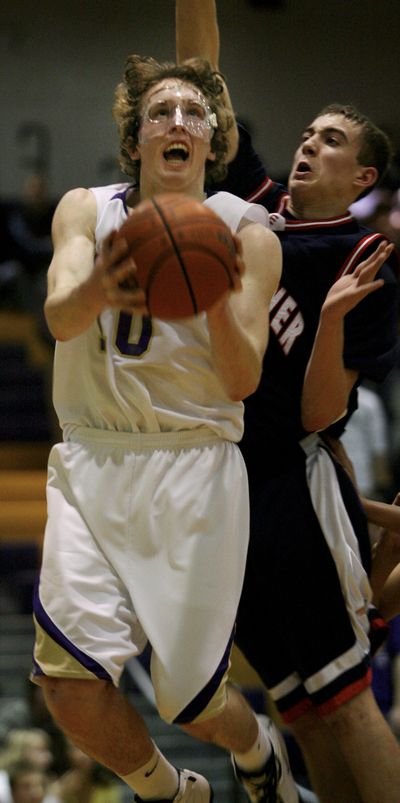 Kam Douglass, left, is shown in a February 2008 basketball game at Wenatchee High School. He suffered about 12 concussions in two years. (FILE Associated Press / The Spokesman-Review)