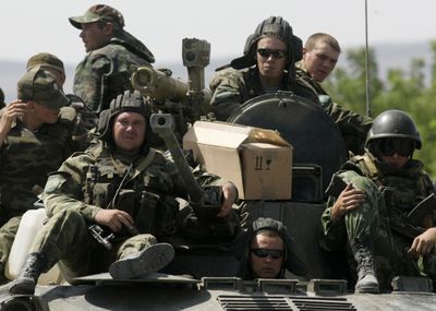Russian soldiers sit atop an armored vehicle in the outskirts of Gori, northwest of the capital Tbilisi, Georgia, on Monday. (Associated Press / The Spokesman-Review)
