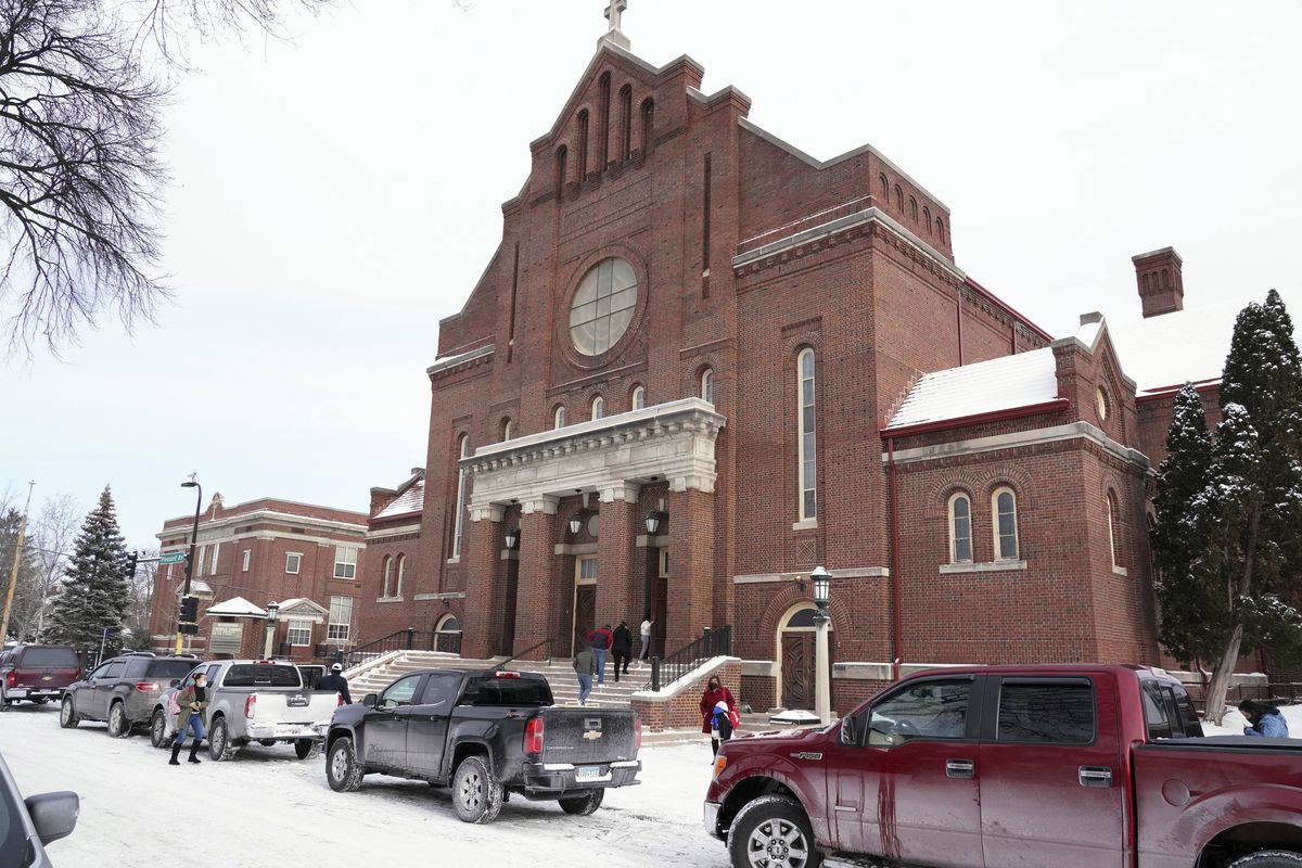 Church of the Incarnation is shown, Sunday, Jan. 23, 2022, in Minneapolis, where residents could pick up coats, sweaters and frozen chicken. With attendance dwindling, historic urban churches built in the early to mid-20th century, are fulfilling their faith-based mission to serve their neighbors. Between mass, people can pick up coats and sweaters along with bags of frozen chicken.  (Jim Mone)