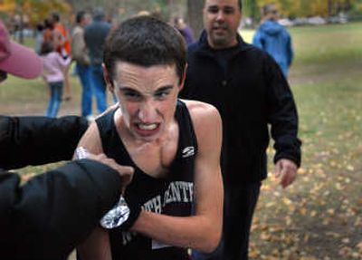 
North Central cross country runner Andrew Kimpel is treated for an arm injury Wednesday after being forced into a tree. 
 (Brian Plonka / The Spokesman-Review)