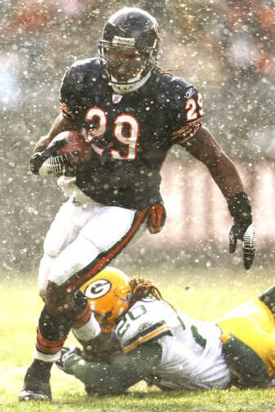 
Chicago's Adrian Peterson breaks tackle of Green Bay's Atari Bigby Sunday in snowy Chicago.Associated Press
 (Associated Press / The Spokesman-Review)