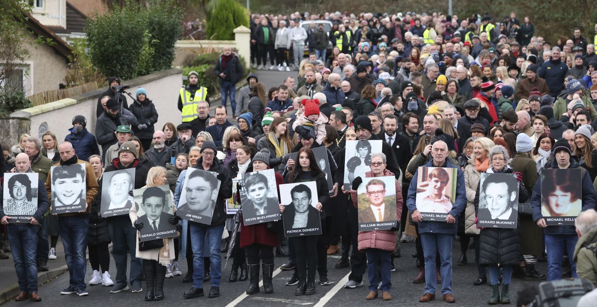 People take part in a march to commemorate the 50th anniversary of the 