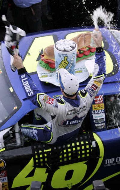 
Jimmie Johnson sprays his team with a drink as he celebrates winning the Subway 500.Associated Press
 (Associated Press / The Spokesman-Review)