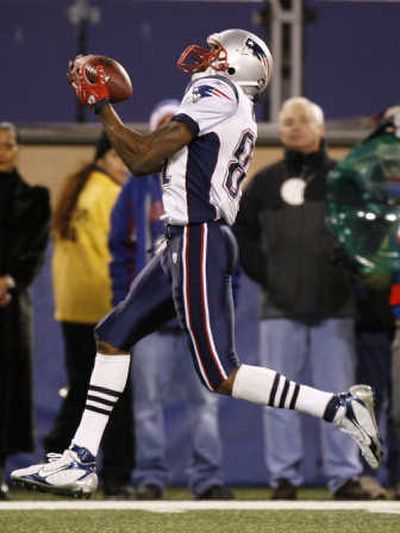 Randy Moss' 65-yard touchdown reception broke records and broke the Giants. Associated Press
 (Associated Press / The Spokesman-Review)