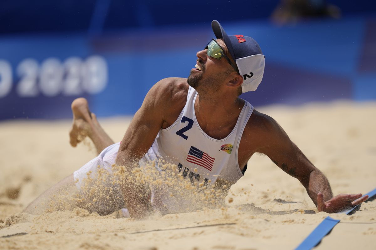 Nicholas Lucena, of the United States, hits the sand ad he competes during a men's beach volleyball match against Argentina at the 2020 Summer Olympics, Thursday, July 29, 2021, in Tokyo, Japan.  (Petros Giannakouris)