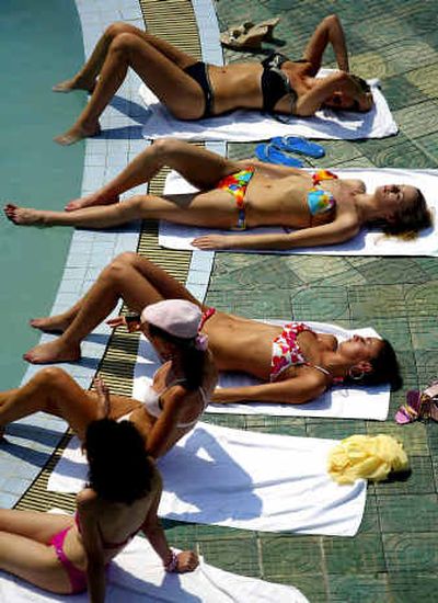 
 Absorbing the sun's UV rays to get tan may be addictive to some sunbathers.
 (Knight-Ridder / The Spokesman-Review)