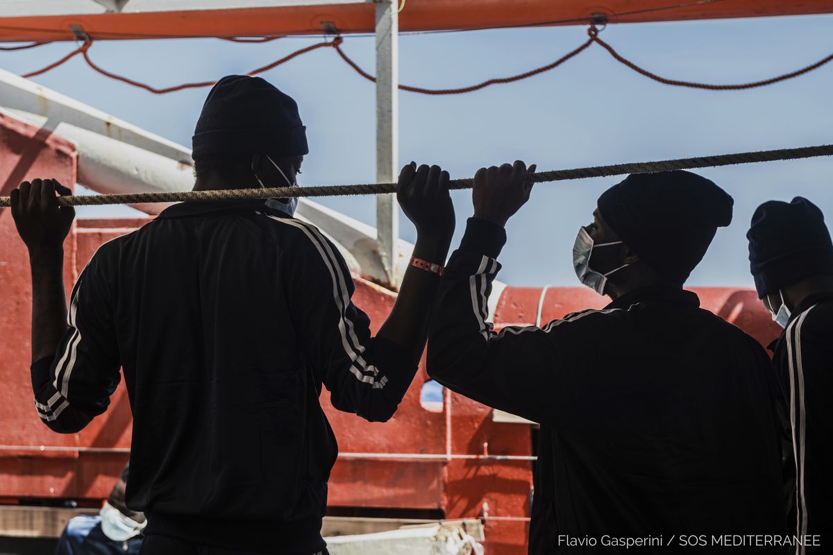 In this photo taken Thursday, April 29, 2021 migrants look at the sea from aboard the Ocean Viking during its navigation in the Mediterranean Sea. SOS Mediterranee said Saturday May 1, 2021 the Ocean Viking was sailing toward a Sicilian port with 236 migrants who were rescued days earlier in the Mediterranean from human traffickers