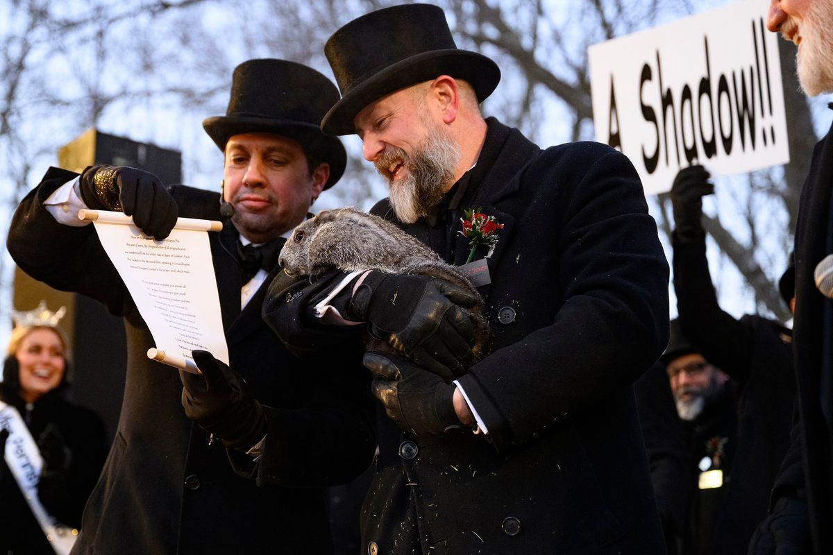 Groundhog handler AJ Dereume holds Punxsutawney Phil after he saw his shadow, predicting six more weeks of winter during the 140th annual Groundhog Day festivities on Monday in Punxsutawney, Pa. If Punxsutawney Phil sees his shadow, he regards it as an omen of six more weeks of bad weather and returns to his den. Early spring arrives if he does not see his shadow, causing Phil to remain above ground.  (Getty Images)
