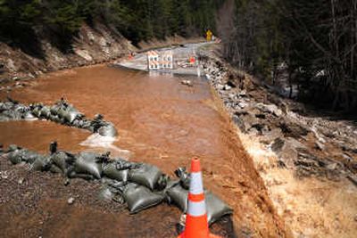 
Water is redirected over the road leading to Mount Spokane last Monday   after melting snow overwhelmed  a culvert. 
 (Rajah Bose / The Spokesman-Review)
