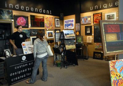 
Art, Music and More owner Seth Everts, left, talks with a visitor at the Spokane Valley Mall store.
 (Holly Pickett / The Spokesman-Review)