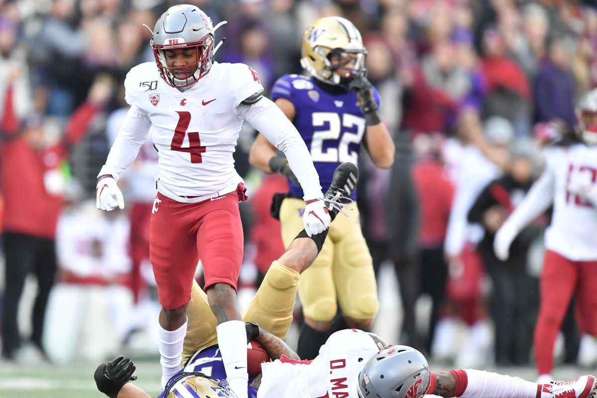 Washington Huskies defensive back Elijah Molden (3) hits the ground against Washington State Cougars wide receiver Davontavean Martin (1) as Washington State Cougars quarterback Gage Gubrud (4) reacts during the first half of a college football game on Friday, November 29, 2019, at Husky Stadium in Seattle, Wash. (Tyler Tjomsland / The Spokesman-Review)