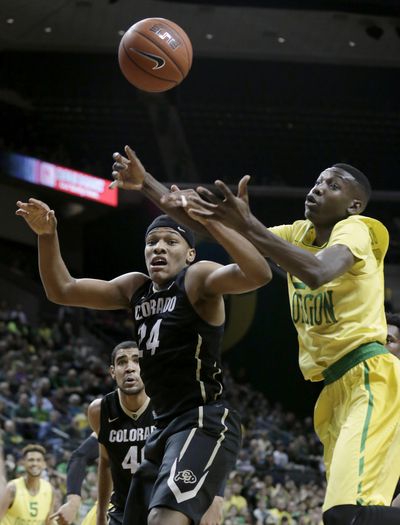 Colorado’s George King, left, and Oregons Chris Boucher look for a rebound during the second half of Thursday’s Pac-12 game in Eugene. (Ryan Kang / Associated Press)