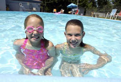 
Alivia Stenson, left, 8, brought her friend Neely Harding, 9, to Evergreen Pool Monday. The pool was built in 1957 and is open to all residents. Parents must supervise their children under age 17 and the pool does not have lifeguards.
 (Photos by J. BART RAYNIAK / The Spokesman-Review)