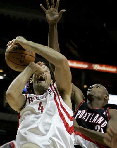 
Houston's Luis Scola loses control of the ball under pressure from Portland's Travis Outlaw.Associated Press
 (Associated Press / The Spokesman-Review)