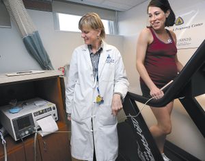 Meredith Dobrosielski, 36, right, exercises on a treadmill in a lab as part of a health study about pregnant women and the effects of exercise in Baltimore. Dobrosielski, an avid runner for several years, was in her 31st week of pregnancy. Dr. Linds Szymanski, maternal fetal medicine fellow, left, is running the tests.   (McClatchy-Tribune)