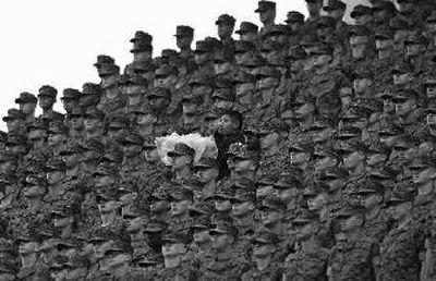 
A cotton candy vendor stands out amid a group of Marine Corps recruits during the seventh-inning stretch of the baseball game between San Diego and Colorado.
 (Associated Press / The Spokesman-Review)