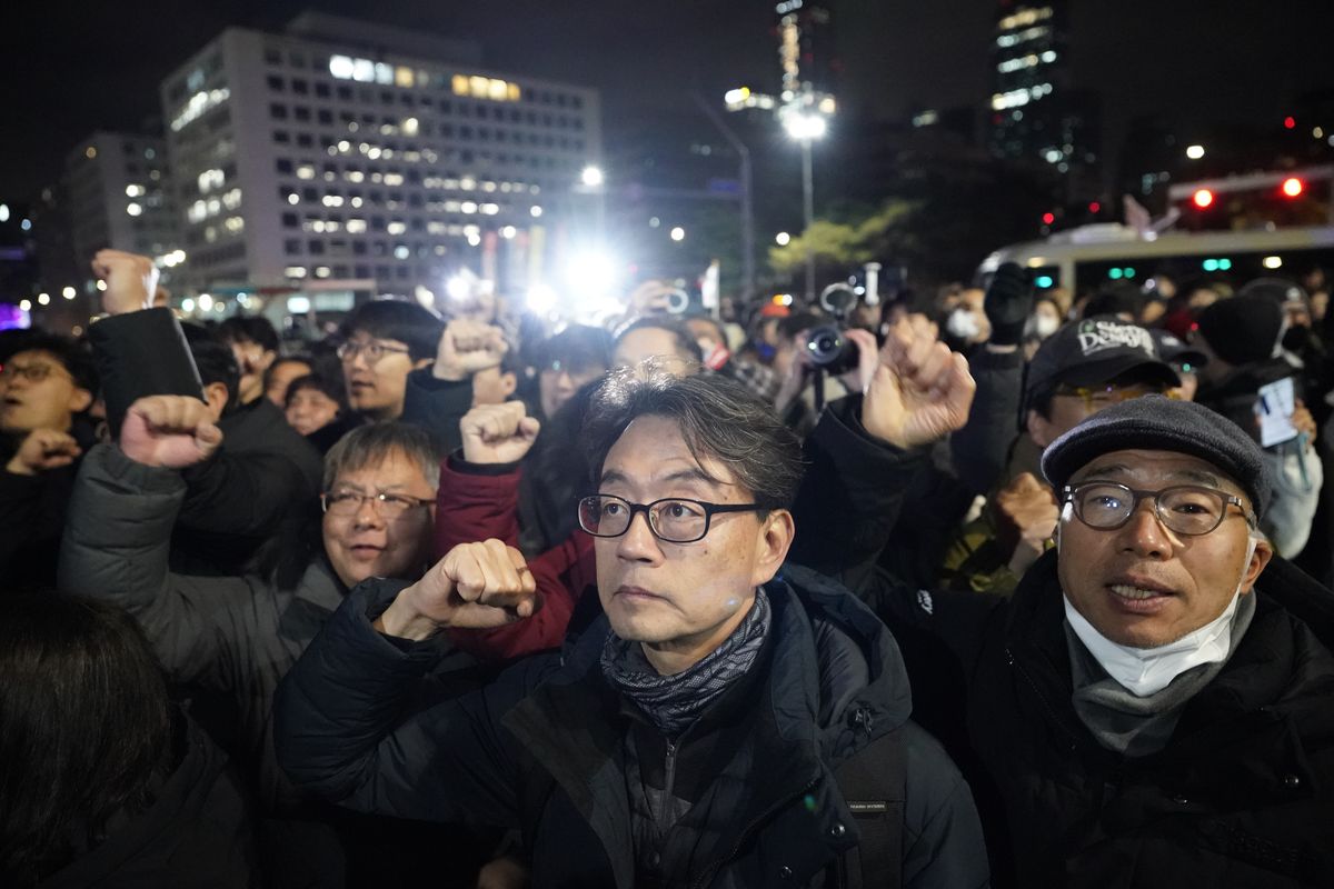 People arrive in front of the National Assembly building.  (Jintak Han/The Washington Post)