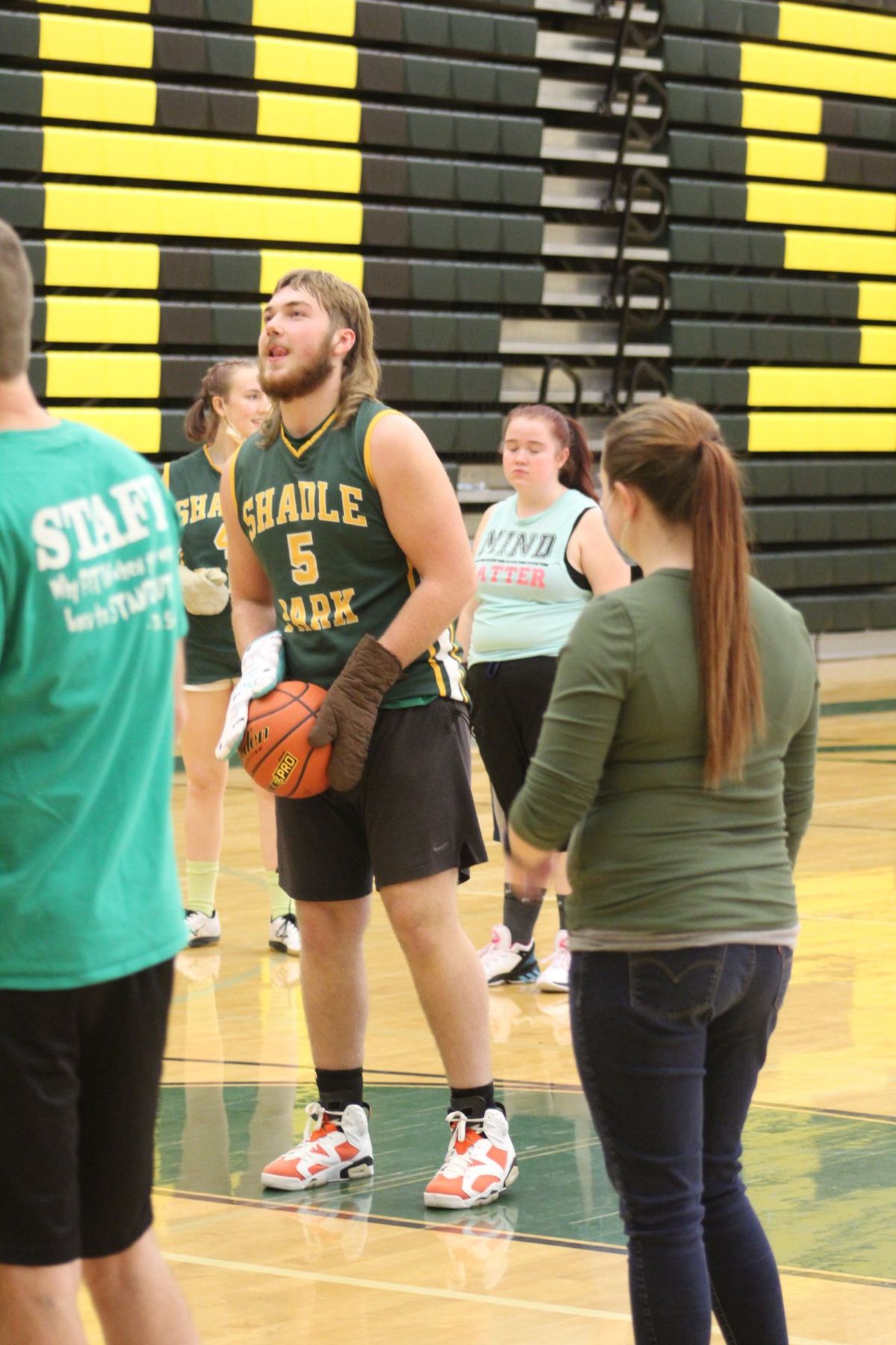 Shadle Park High School junior Luke Owens prepares to attempt a free-throw shot with oven mitts on during the Staff vs Student Basketball Game on Monday December 6, 2021. Jordan Tolley-Turner/The Spokesman-Review.  (Jordan Tolley-Turner/The Spokesman-Review)