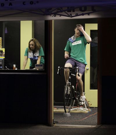 Conor Gentes, right, who works in marketing for the Jones Soda Co., and Susan Rozewski, who is director of human resources, ride bicycles to power office equipment Wednesday at the company’s Seattle headquarters.  (Associated Press / The Spokesman-Review)