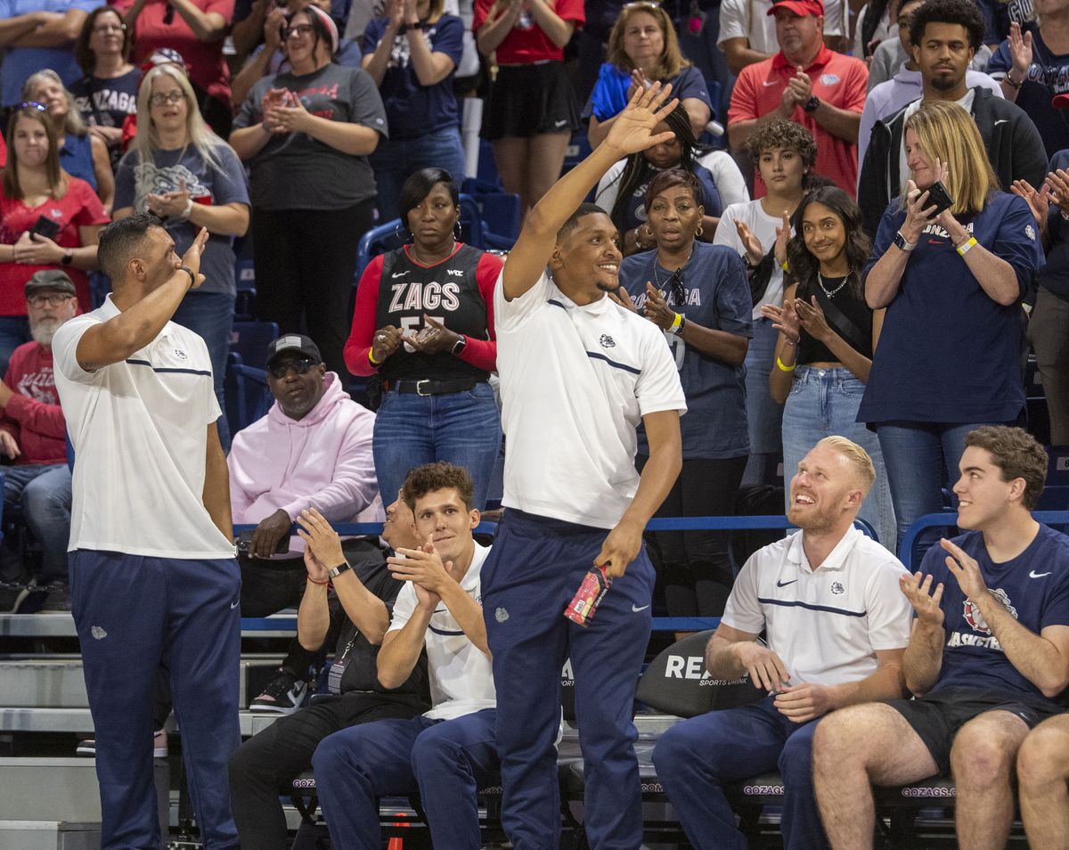 Former Gonzaga players J.P. Batista, left, and Zach Norvell, right, acknowledge the standing-room-only crowd after they were announced as part of the team’s coaching staff at Kraziness in the Kennel night at Gonzaga University Saturday, Oct. 8, 2022.  (Jesse Tinsley / The Spokesman-Review)